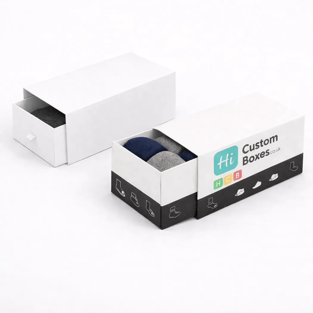Two sleek white drawer-style slide boxes- with the branded version partially open to show socks- class=